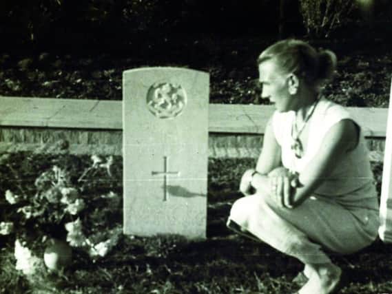 Kate, the sister of Corporal Binks, visits his grave in Italy