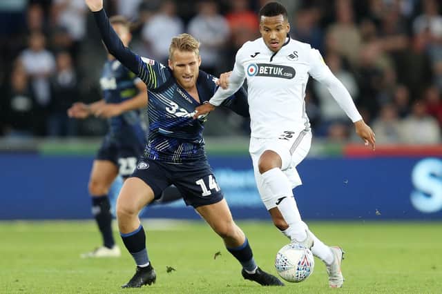 Swansea City's Martin Olsson holds off Leeds United's Samuel Saiz during the Sky Bet Championship match at the Liberty Stadium, Swansea. PRESS ASSOCIATION Photo. Picture date: Tuesday August 21, 2018. See PA story SOCCER Swansea. Photo credit should read: David Davies/PA Wire. RESTRICTIONS: EDITORIAL USE ONLY No use with unauthorised audio, video, data, fixture lists, club/league logos or "live" services. Online in-match use limited to 120 images, no video emulation. No use in betting, games or single club/league/player publications.
