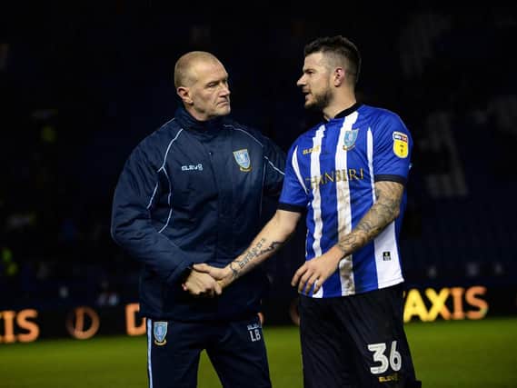 Owls Coach Lee Bullen shakes hands with Daniel Pudil at the final whistle after their draw with Rotherham United