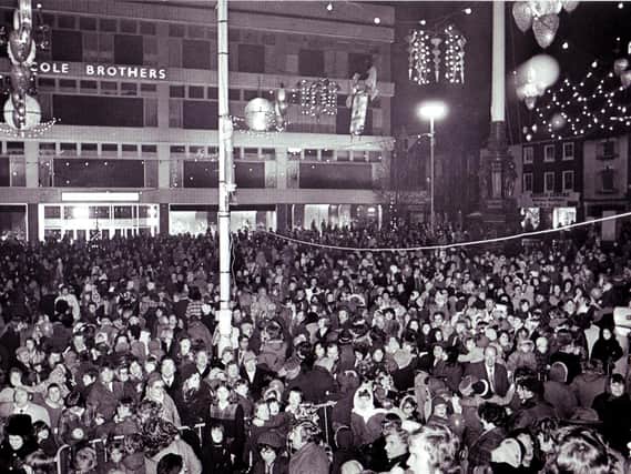 Crowds gather to see the Christmas lights switch-on at Barker's Pool in 1974