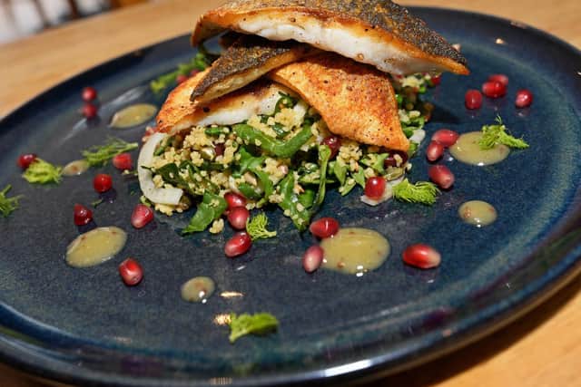 Pan Fried Seabass, served with Cous Cous, Spinach, Fennel, Pomegranate Salad and Honey and Wholegrain Mustard dressing. One of the Main dishes available at Olive Mediterranean restaurant. Picture: Marie Caley NSTE Olive MC 2