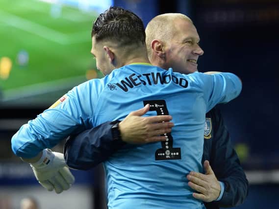 Keiren Westwood hugs Lee Bullen after Sheffield Wednesday's win over Preston