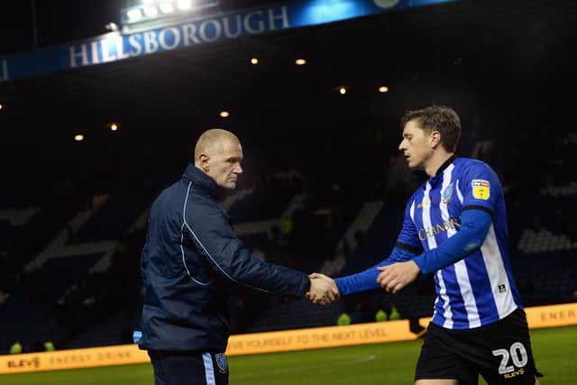 Owls Coach Lee Bullen shakes hands with Adam Reach at the final whistle......Pic Steve Ellis