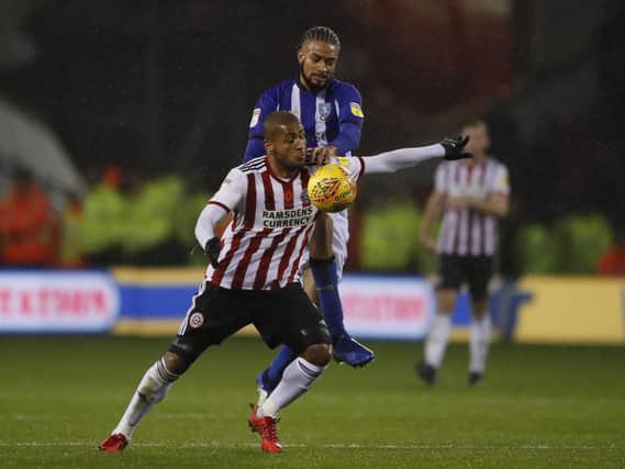 Michael Hector of Sheffield Wednesday tackles Leon Clarke of Sheffield Utd during the Sky Bet Championship match at Bramall Lane
