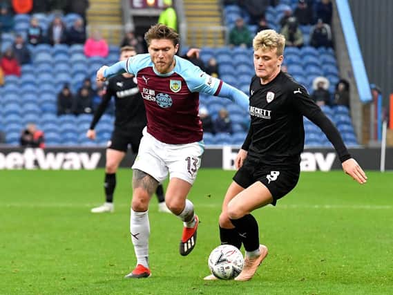Burnley's Jeff Hendrick and Barnlsey's Cameron McGeehan battle for the ball during the Emirates FA Cup, third round match at Turf Moor, Burnley. Photo: Dave Howarth/PA Wire.