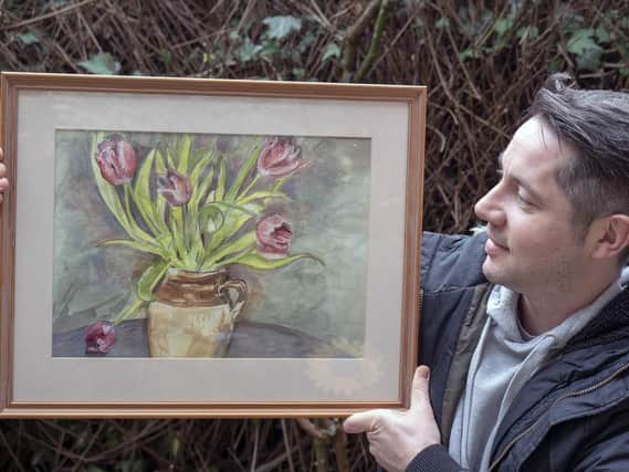 Gavin Douglas with artwork by his mother Alison, which he will sell at The Under The Bed Sale at Sheffield Hillsborough's Cupola Gallery. Picture Scott Merrylees.