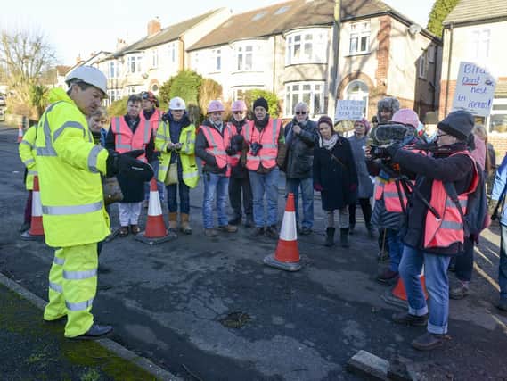 Workers from Amey prepare the road around  a tree on Chatsworth Road in sheffield for remedial work
Nick Hetherington explains the course of work that will be carried out to STAG members