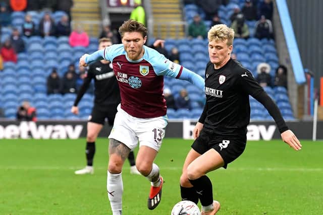 Burnley's Jeff Hendrick (left) and Barnsley's Cameron McGeehan (right) battle for the ball during the Emirates FA Cup, third round match at Turf Moor, Burnley. Pic: Dave Howarth/PA Wire.