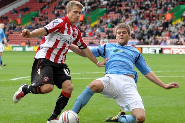 Coventry's Ben Turner and Jamie Ward, while eat Sheffield United