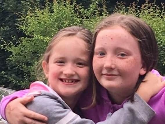 Eight-year-old Lily Atkinson, from Hoyland, Barnsley (left), with her sister Grace