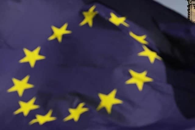 An EU flag flies in the face of Parliament