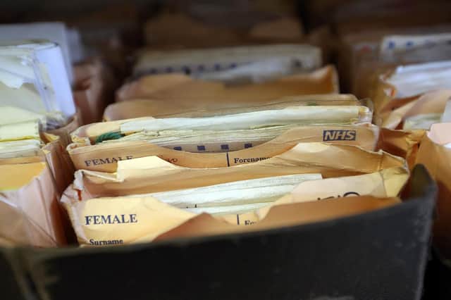 Folders containing patient records are pictured in a General Practitioners surgery  (Photo by Carl Court/Getty Images)