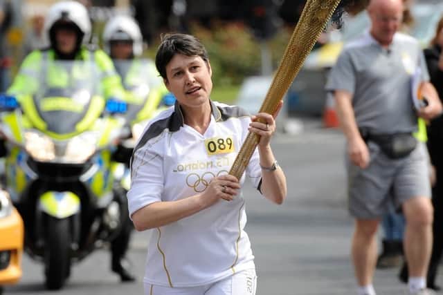 Vikki Orvice carrying the Olympic Flame on the Torch Relay leg between Barnsley and Kexbrough. (Picture: LOCOG/Press Association Images)