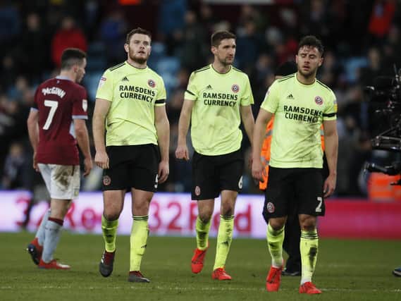 Jack O'Connell, Chris Basham and George Baldock leave the field frustrated during the Sky Bet Championship match at Villa Park Stadium