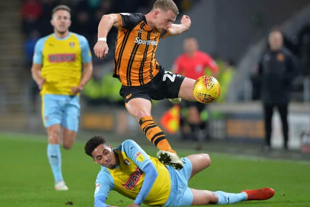 Stephen Kingsley leaps to avoid Zak Vyner as he slides in. Picture Bruce Rollinson