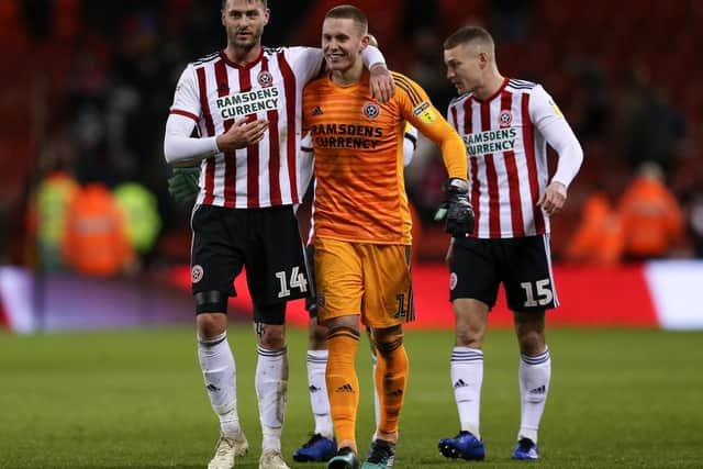Gary Madine (left) embraces Dean Henderson (centre) as they celebrate Sheffield United's win with Paul Coutts: James Wilson/Sportimage