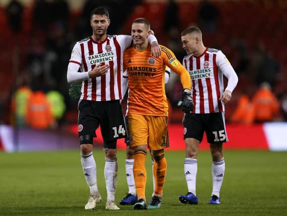 Gary Madine (left) embraces Dean Henderson (centre) as they celebrate Sheffield United's win with Paul Coutts: James Wilson/Sportimage