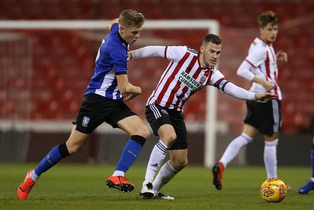 Jack Lee of Sheffield Wednesday tackles Paul Coutts of Sheffield Utd during the Professional Development League North match at Bramall Lane Stadium, Sheffield.  James Wilson/Sportimage