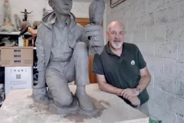 Artist Graham Ibbeson with his Kes sculpture