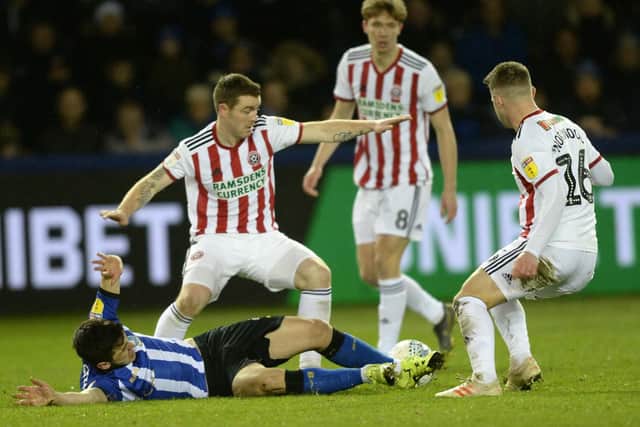 Fernando Forestieri and John Fleck tussle in the Steel City derby at Hillsborough