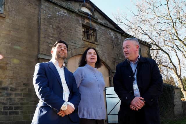 Building Better Parks: Steve Chu of Age UK with Cllr Mary Lea and James Barnes of Sheffield's Parks Dept looking at the courtyard of the old Hillsborough Park coach house. Photo by David Bocking.