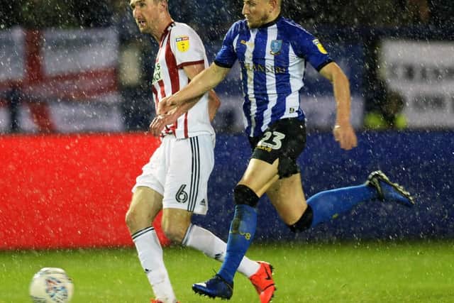 Owls Sam Hutchinson closes down Blades Chris Basham.......Pic Steve Ellis