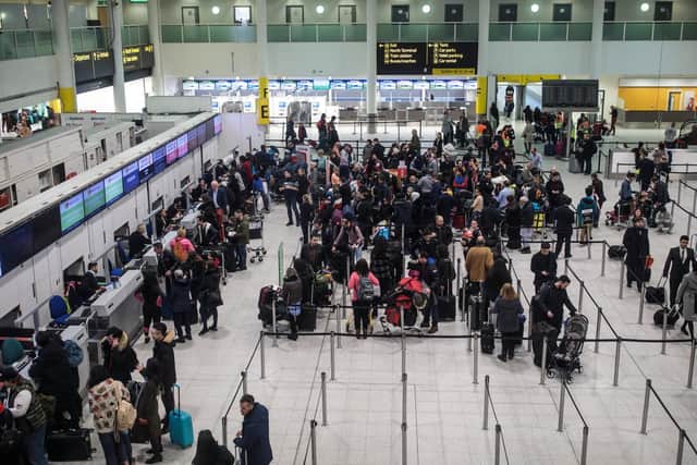 Passengers queue in the South Terminal building at London Gatwick Airport (Photo by Jack Taylor/Getty Images)