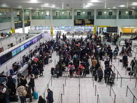 Passengers queue in the South Terminal building at London Gatwick Airport (Photo by Jack Taylor/Getty Images)