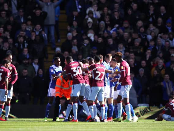 A fan attacks Aston Villa's Jack Grealish on the pitch (right) during the Sky Bet Championship match at St Andrew's Trillion Trophy Stadium, Birmingham.Nick Potts/PA Wire.