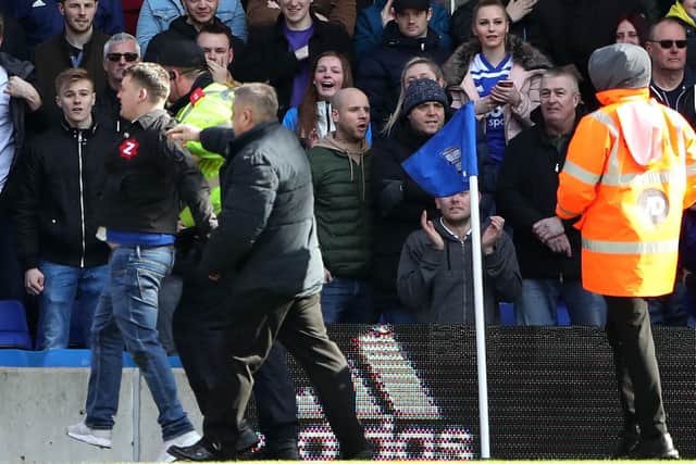 Paul Mitchell (left, on pitch, blue jeans) being escorted from the pitch after attacking Aston Villa's Jack Grealish during the Sky Bet Championship match at St Andrew's Trillion Trophy Stadium, Birmingham. Picture: Nick Potts/PA Wire