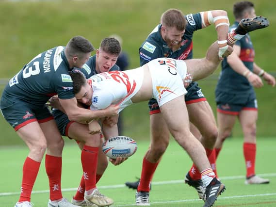 Leigh get to grips with Eagles Lewis Taylor. Pic Steve Ellis