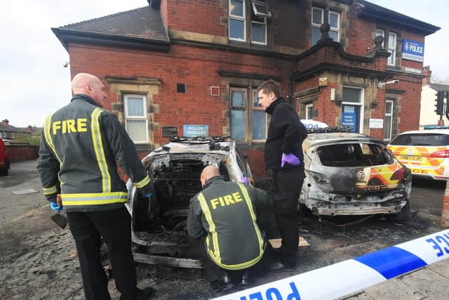 Police investigate after two police cars and a council van were destroyed in an arson attack outside Goldthorpe police station in Barnsley (pic: Danny Lawson/PA Wire)