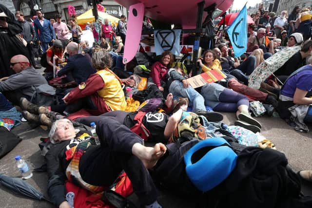 Climate activists surround a pink boat that has been parked during an Extinction Rebellion demonstration at Oxford Circus, London. Picture: Yui Mok/PA Wire.