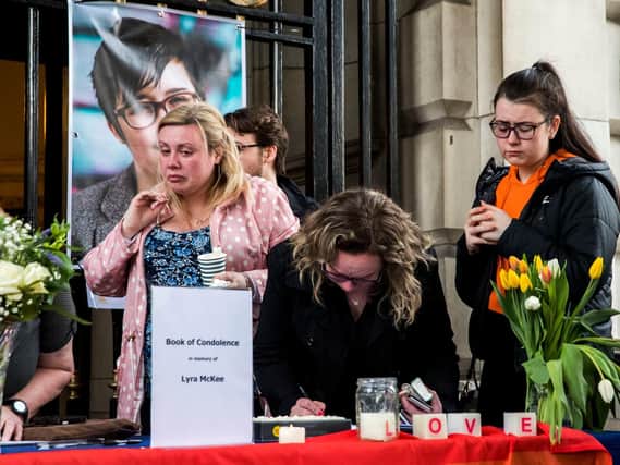 People signing a book of condolence after a vigil at Belfast City Hall in memory of murdered journalist Lyra McKee (pic:  Liam McBurney/PA Wire)