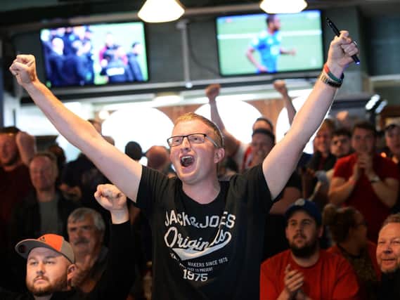 Blades fans celebrate in the Clubhouse, London Road after watching Leeds' draw with Villa on TV at Sunday lunchtime confirming Sheffield Uniteds promotion to the Premier League. Picture: Steve Ellis