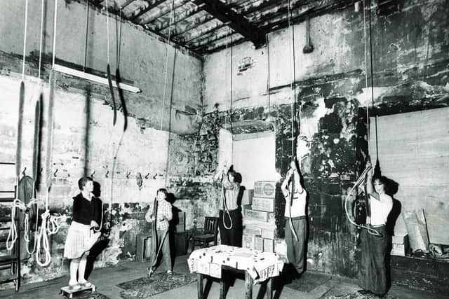 The Sheffield Cathedral bells ring once more after the fire.  This picture shows (from left) Helen Sparks (12), Lucy Johnston (12), Mr Ron Johnston, Mr Herbert Chaddock and Mr David Munday, as they ring out the first chords. Fire damage can be seen on the walls and in the roof timbers, July 26, 1979
