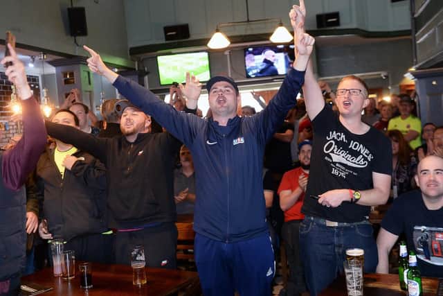 Blades fans celebrate in the Clubhouse, London Road after watching Leeds draw with Villa on TV at Sunday lunchtime confirming Sheffield United's promotion to the Premier League. Picture: Steve Ellis