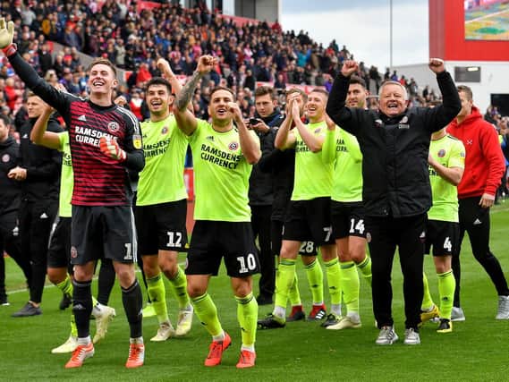Sheffield United manager Chris Wilder (right), Billy Sharp (centre) and goalkeeper Dean Henderson (left) celebrate promotion to the Premier League: Dave Howarth/PA Wire.