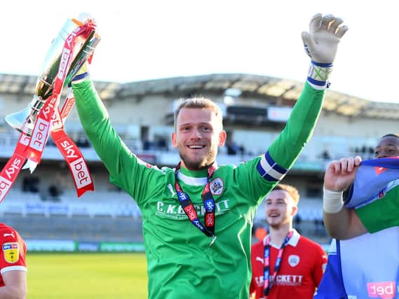 Adam Davies of Barnsley celebrates with the second place trophy after getting promoted following during the Sky Bet League One match between Bristol Rovers and Barnsley at Memorial Stadium on May 04, 2019  (Photo by Harry Trump/Getty Images)
