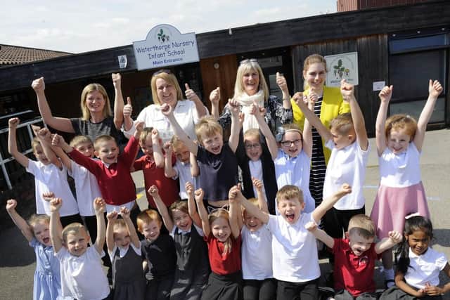 Pictured are staff and Y1B pupils of Waterthorpe Nursery Infant School, Waterthorpe, celebrating a good Ofsted report