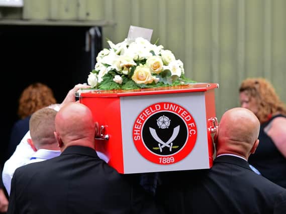 The red-and-white coffin of 15-year-old Blades fan Ryan Durkin is carried into his funeral at Magna (pic: Marie Caley)