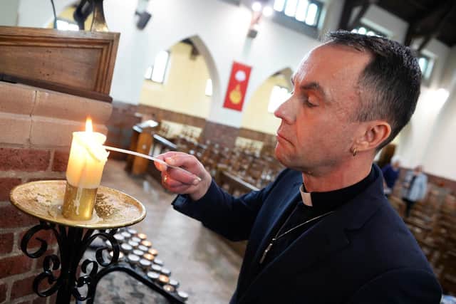 Reverend David Dean-Revill lights a candle for the tragic teenagers (pic: Steve Ellis)
