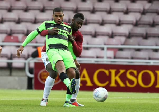 NORTHAMPTON, ENGLAND - OCTOBER 13:   Reuben Reid of Forest Green Rovers controls the ball under pressure from Aaron Pierre of Northampton Town during the Sky Bet League Two match between Northampton Town and Forest Green Rovers at the PTS Academy Stadium on October 13, 2018 in Northampton, United Kingdom. (Photo by Pete Norton/Getty Images)