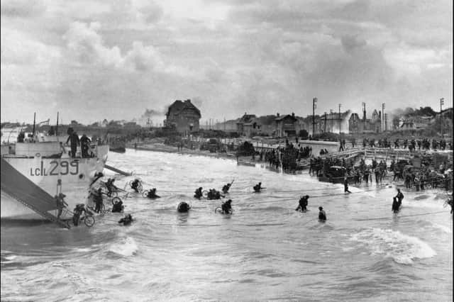 Operation Overlord (The Normandy Landings): D-Day 6 June 1944, The British 2nd Army: second-wave troops of 9th Canadian Infantry Brigade, probably Highland Light Infantry of Canada, disembarking with bicycles from LCI(L)s (Landing Craft Infantry Large) onto 'Nan White' Beach, JUNO Area at Bernieres-sur-Mer, shortly before midday on 6 June 1944. (Photo by Canadian Official Photographer/ IWM via Getty Images)