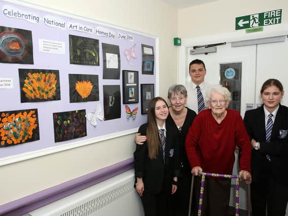 Residents Pat and May with Wales High School pupils Paige, Ethan and Ellen and some of the Art in Care exhibition at Ladyfield House (Photo: Glenn Ashley)