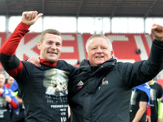 Paul Coutts (left) and manager Chris Wilder celebrate promotion to the Premier League: Dave Howarth/PA Wire.