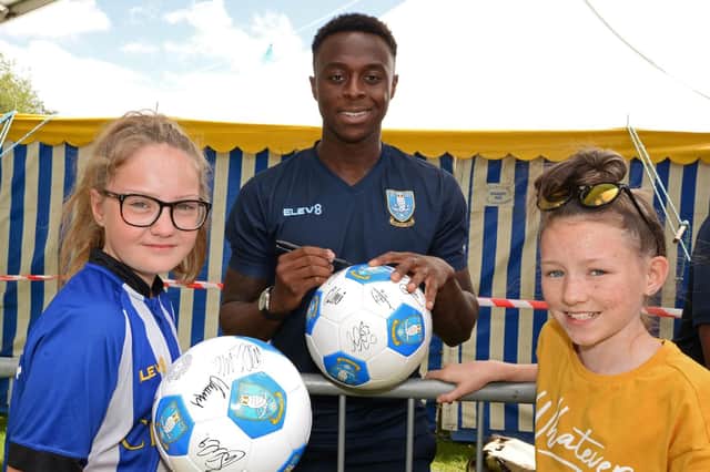 New Owls signing Moses Odubajo is pictured with Olivia Barks, 11 and Leela Cranswick, ten, at Owls in the Park