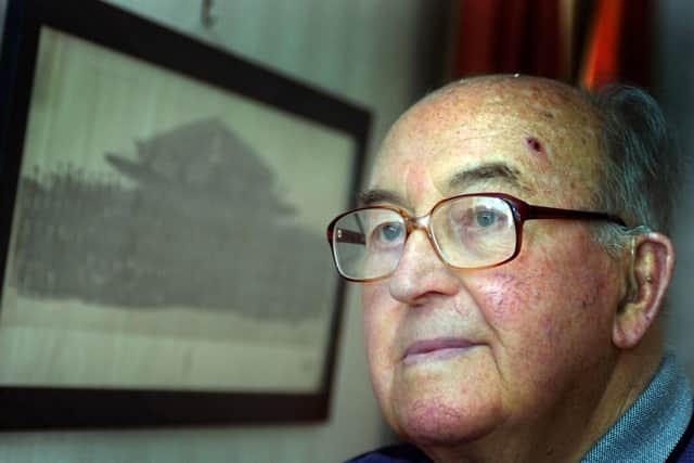 Former Lancaster Bomber pilot Dick Starkey with a picture of his squadron during World War Two.