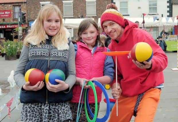 Circus Show at Crowle Market Place - pictured are Lauren Watson and Grace Kaye, both aged 10, with Karl Robson of Party Workshop.