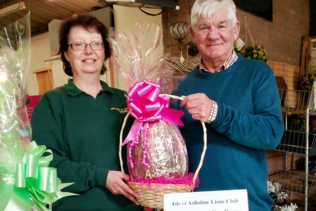 Bev Rockliffe receiving an egg on behalf of the staff at Holmes & Garden's, presented by Isle of Axholme Lion's vice president Graham Guest.